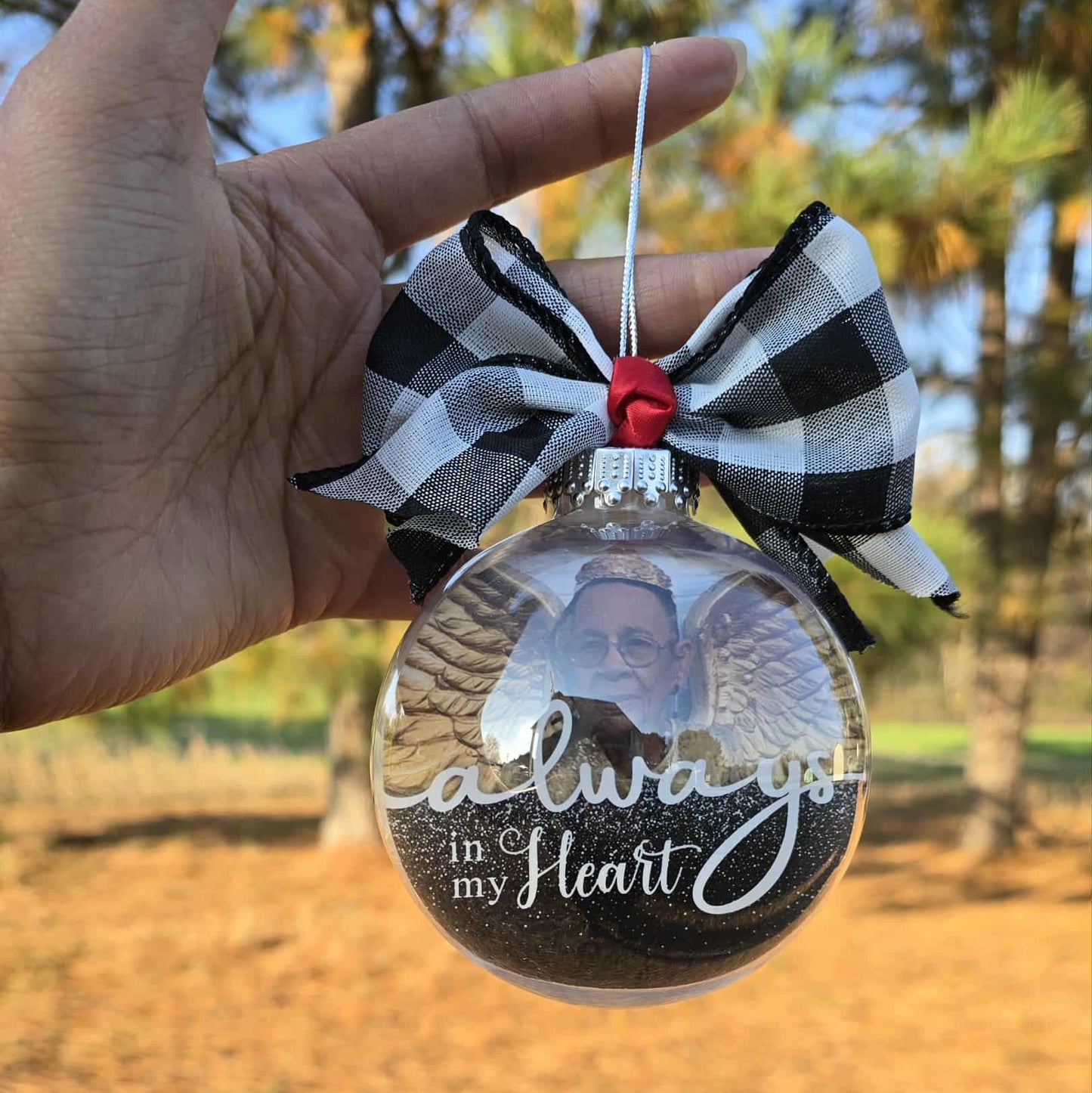 Decorative ornament with a black and white buffalo plaid checkered bow.